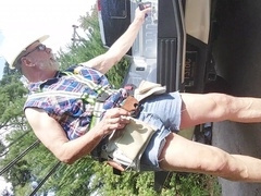 Construction father tak8ng a break, smoking a cigar