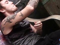 Tattooed gay stud takes clothes off and masturbates while smoking