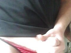 Playing in red satin string bikini panties