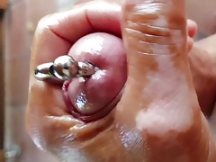 Wanking oiled pierced hard cock and cum