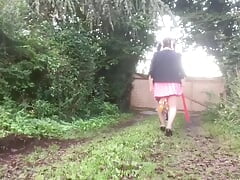 In school attire with a pink pleated skirt on the outside