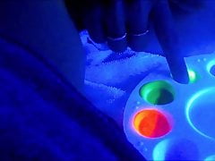 She paints on his big cock in UV light!