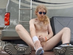 Bearded ginger nudist finishes outside and plays with his soles