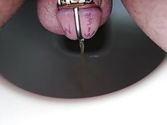 Chaste guy peeing through urethra tube