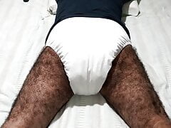 WATCHING TELEVISION LYING DOWN WEARING WHITE DIAP...