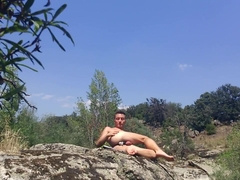 Gay male spread his legs and ass to take an anal vibrator in a public park