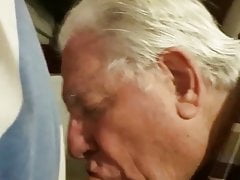 Clothed grandpa sucking hairy man's cock in bed