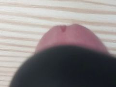 Squeezing dick on the table with magic wand