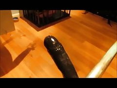 Slave impaling himself on large dildo