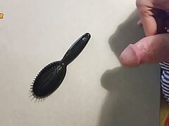 Jerking off on a small hairbrush, cumshot with a lot of cum from a big cock by an handjob.