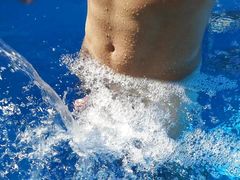 German Guy in the swimming pool enjoying the Waterfall