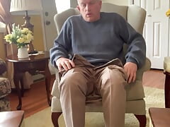 Older man masturbating with legs spread wide