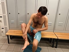 Playing with feet and dick in the locker room
