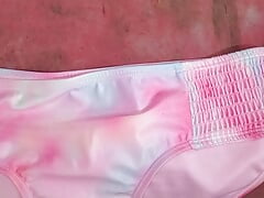 playing with pink bikini bottom in auto shop